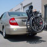TRILIFT Ultra Lite carrying a manual wheelchair on a Toyota Camry.